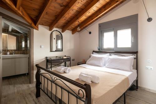 una camera da letto con un grande letto con asciugamani di Tsatos Luxury Residence a Kremasti
