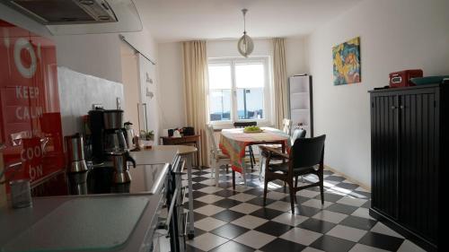 a kitchen with a black and white checkered floor at Ferienwohnung Meine Tante in Trittenheim