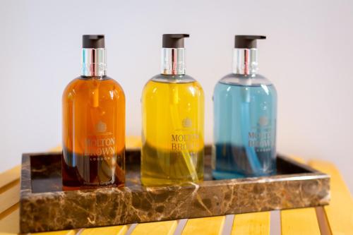 three bottles of alcohol sitting on a stone shelf at Landgoed Dennenholt - 5 unique holiday homes in Vierhouten