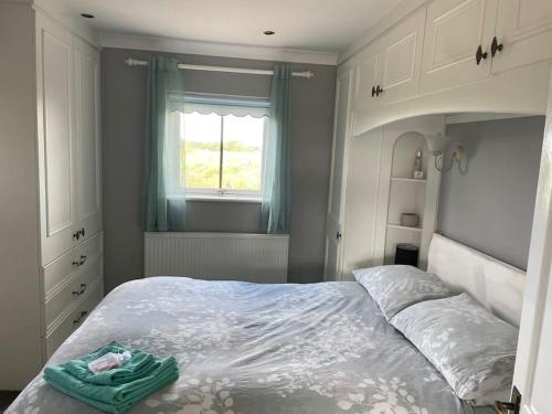 Un dormitorio con una cama con una toalla verde. en The Bungalow en Preston