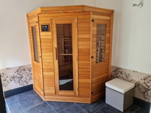 a wooden cabinet with a toilet in a room at Lyon Faubourg - Saint Priest in Saint-Priest