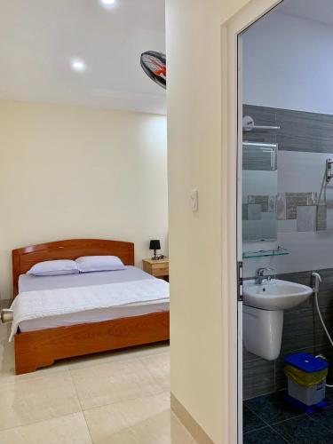 a bedroom with a bed and a sink at Motel Phương Thảo Phong Tập Thể in Vung Tau