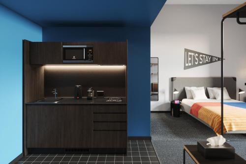 a bedroom with a bed and a sink and a microwave at The Social Hub Toulouse in Toulouse