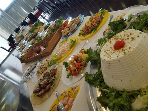 a table with many plates of food on it at Hotel Admeto in Marinella di Selinunte