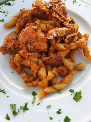 a white plate of food with a pile of fries at Hotel Admeto in Marinella di Selinunte