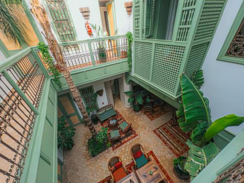 an overhead view of a balcony with tables and chairs at Riad Lalla Mimouna in Marrakech
