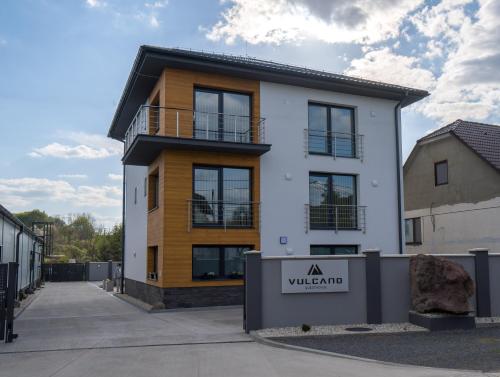 a building with a sign in front of it at VULCANO Guesthouse in Vinica