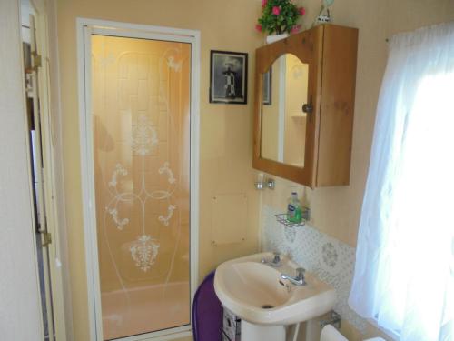 a bathroom with a sink and a shower at 6 Berth central heated on The Chase (Brentmere) in Ingoldmells