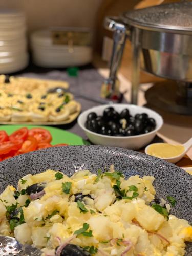 a plate of food on a table with vegetables at Labirint Boutique Hotel in Bucharest
