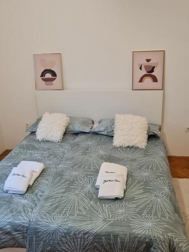 a bedroom with a bed with two pillows on it at Apartment Donna Rijeka in Rijeka