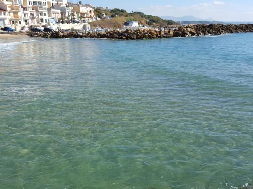 a large body of water with houses and a beach at Hotel Admeto in Marinella di Selinunte