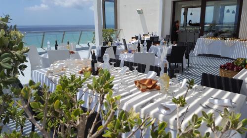 a table set up for a wedding with the ocean in the background at Hotel Admeto in Marinella di Selinunte