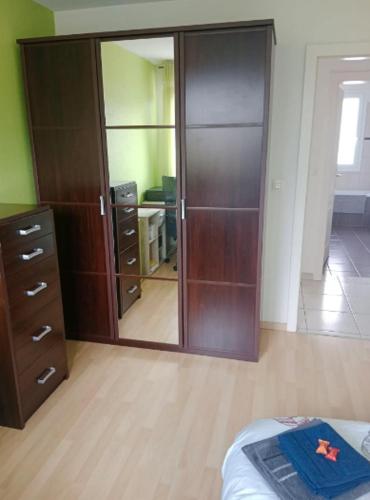 a bedroom with a closet and a dresser and a mirror at Chambre #3 dans appartement partagé - Proche des Vosges in Thann