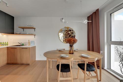 a kitchen and dining room with a table and chairs at Boutique Aura 40 by Grand Apartments in Gdańsk