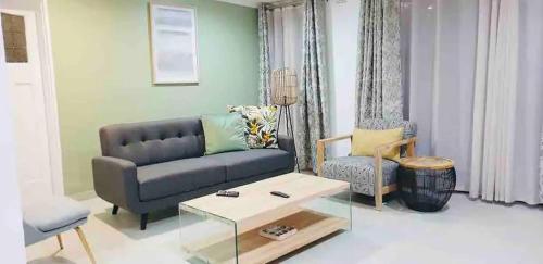 a living room with a couch and a coffee table at Contemporary 2 bed in Suburbs - 2080 in Bulawayo