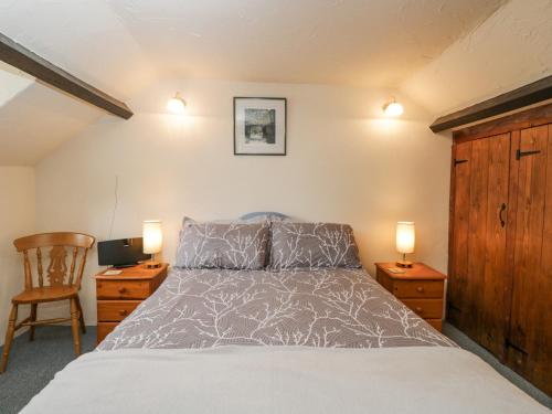 a bedroom with a bed and a desk and a chair at The Old Bakery in Beaminster