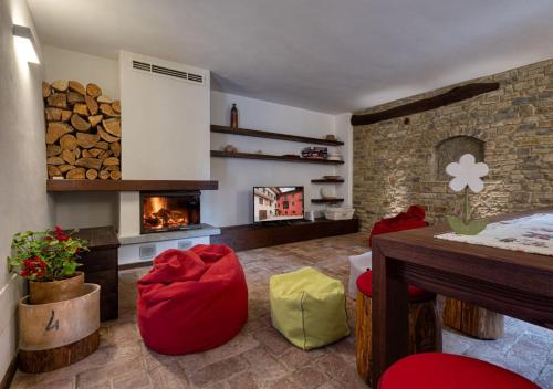 a living room with a fireplace and a table at B&B La Ceramica Moline in Vicoforte