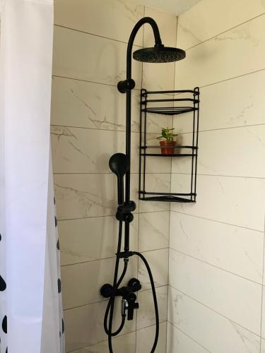 El baño incluye ducha con cabezal negro. en Casa di Angelo en Cos