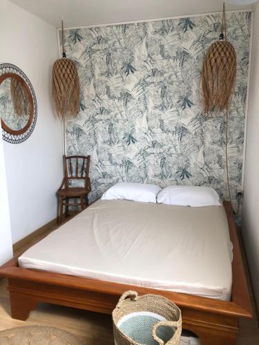 a bed in a room with a wall at 2 cap beach in Saint-Pierre