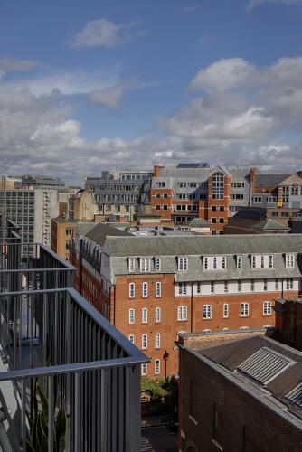 a view of a city from the balcony of a building at Hotel AMANO Covent Garden in London