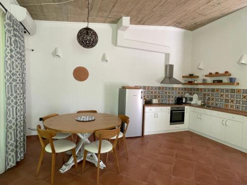una cucina con tavolo e sedie in una stanza di Къща за гости “ ОАЗИС “ ет.2 a Lozenets