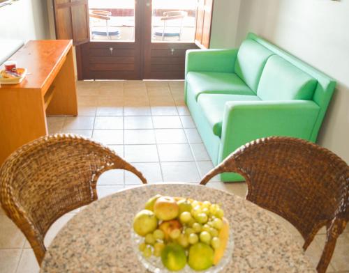 a plate of fruit on a table in a living room at Garbos Soleil Hotel in Natal