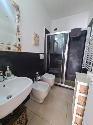 a bathroom with a white sink and a toilet at Casa di Bianca by PortofinoVacanze in Santa Margherita Ligure