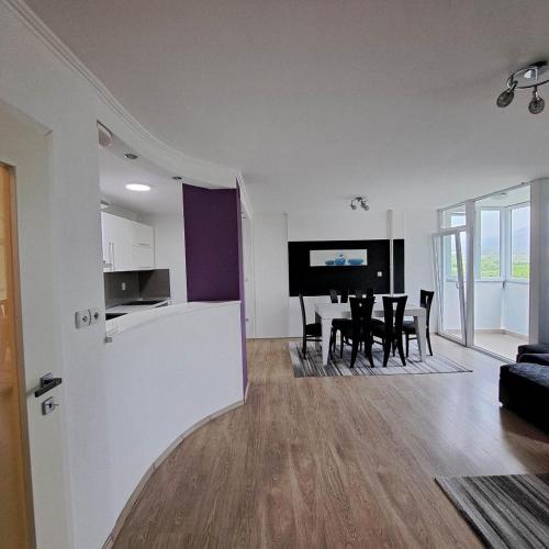 a living room with a kitchen and a dining room at Jove Apartments in Bitola