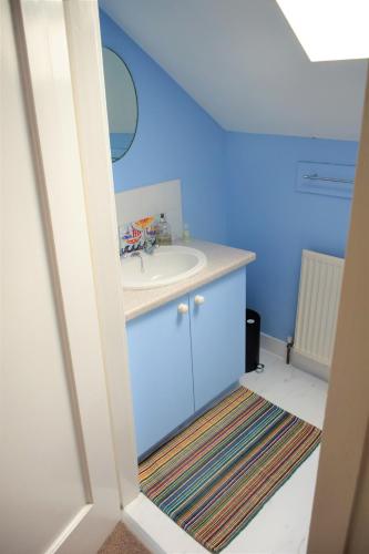 a bathroom with a sink and a mirror at The Stables in Carsethorn