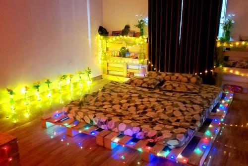 a bedroom with a bed covered in logs and lights at Mihome in Hai Phong