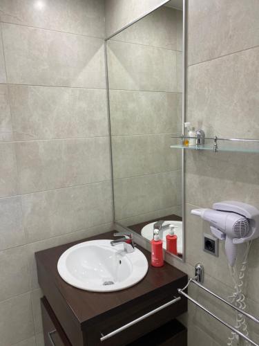 a bathroom with a sink and a mirror at Silver Mountain C24 Royal in Poiana Brasov
