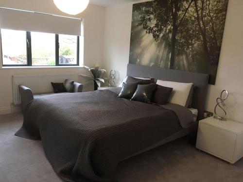 a bedroom with a large bed with a large painting on the wall at Luxury detached house - Village 