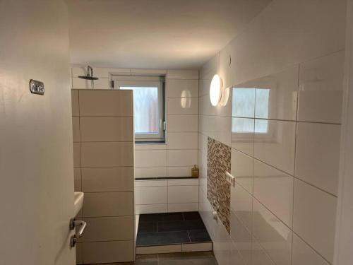 a bathroom with a shower and a toilet and a window at TTP 15 Markdorf in Markdorf