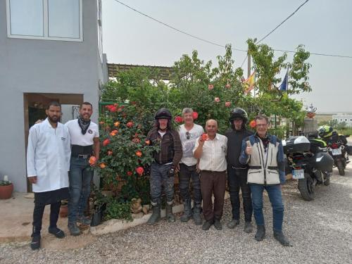 a group of men standing in front of a bush at Motel Ain Mersa in Ifrane