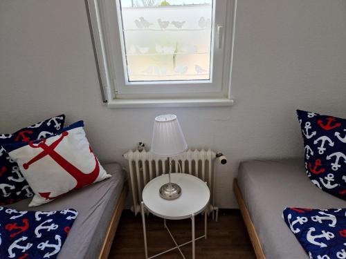 a room with a bed and a table with a lamp at Feriengarten Dahme W 3 in Dahme