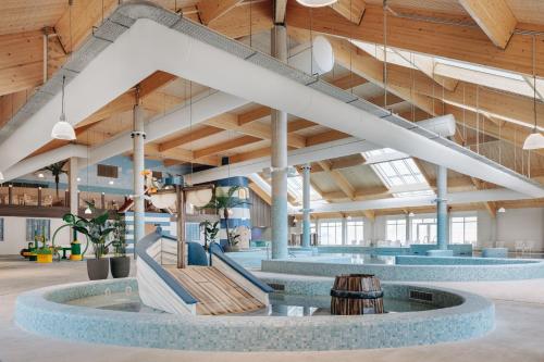 a large lobby with a staircase in a building at NV 1013 - Beach Resort Nieuwvliet Bad in Nieuwvliet