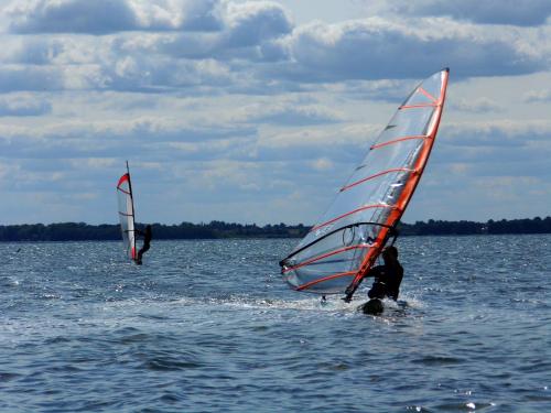 two people windsurfing in the water on a lake at Ferienhaus Liwi in Liessow