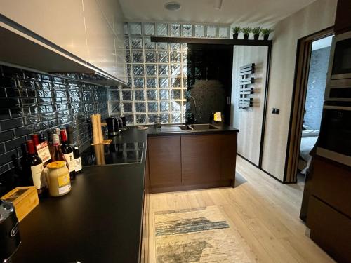a kitchen with a black counter and a counter top at Pod Lwem in Kościerzyna