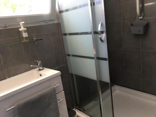 a bathroom with a shower and a sink at Le mazet in La Londe-les-Maures