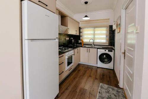 a kitchen with a refrigerator and a washer and dryer at Luxuriant Houses Kyrenia in Kérynia