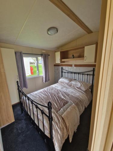 a bedroom with a large bed in a room at Taylor's Highland Escape, Dornoch in Dornoch