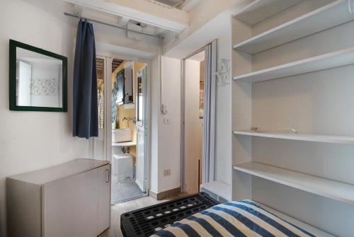 a small bathroom with a bed and a sink at Alloggio di Charme in Bonassola