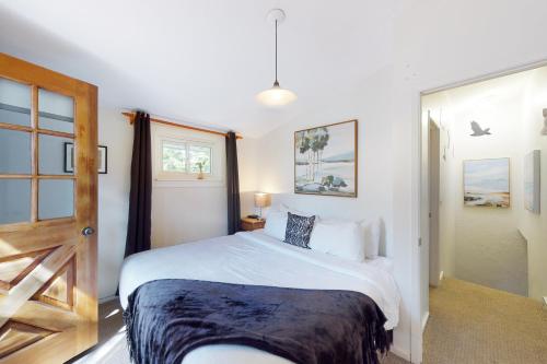 a bedroom with a white bed and a window at 112 Birchview Trail in Blue Mountains