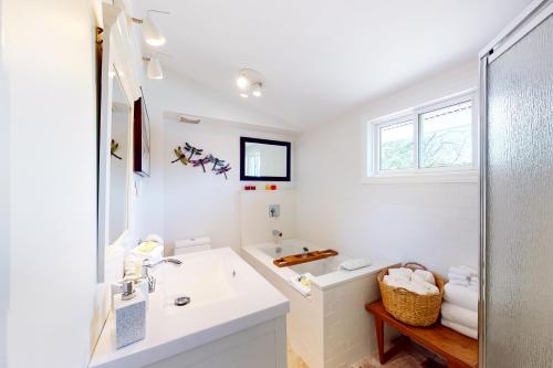 a white bathroom with a sink and a tub at 112 Birchview Trail in Blue Mountains