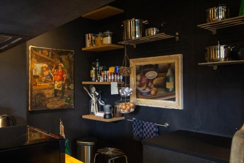 a kitchen with two pictures on the wall at Tailors Trail Beaufort Holiday Home and Rooms in Mullerthal in Beaufort