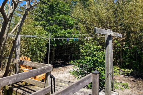 a wooden fence with a gate with a rope at Casa de Zeus in Ocean Bay Park
