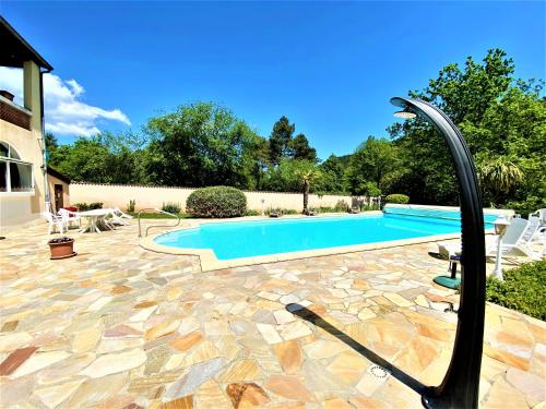 a swimming pool with a hose coming out of it at Gîte et chambres d'hôtes LE MERCOIRE in Aubenas