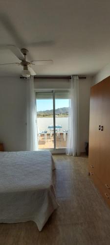 a bedroom with a bed and a view of the ocean at Esparto y sal in El Pozo de los Frailes