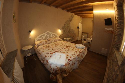 a bedroom with a large bed in a room at Locanda Vecchia Osteria in Varese