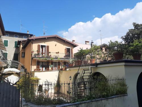 a house with a fence in front of it at Casa castel in Gargnano